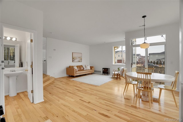 dining room featuring light wood finished floors and visible vents