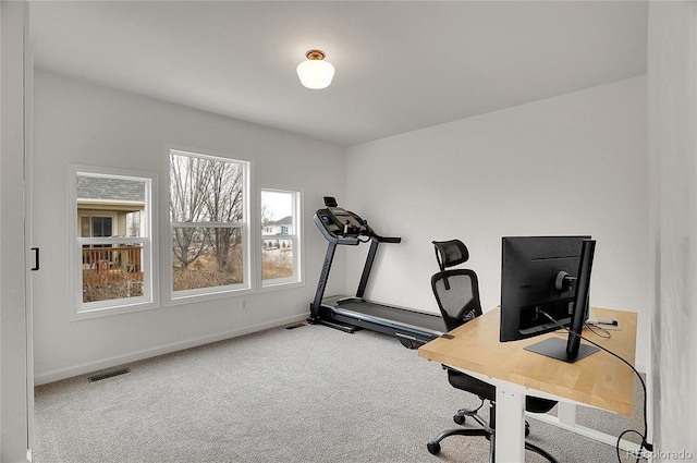 home office featuring carpet floors, visible vents, and baseboards