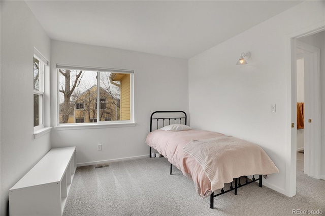 bedroom with carpet flooring, visible vents, and baseboards