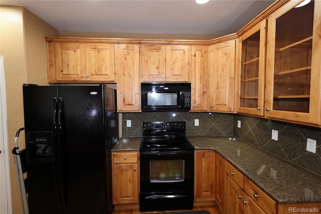 15501 E 112th Ave Unit 20C, Commerce City, CO 80022 - kitchen featuring black appliances, decorative backsplash, dark stone countertops, and glass insert cabinets