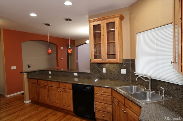 15501 E 112th Ave Unit 20C, Commerce City, CO 80022 - kitchen with black dishwasher, arched walkways, light wood-style floors, tasteful backsplash, and pendant lighting