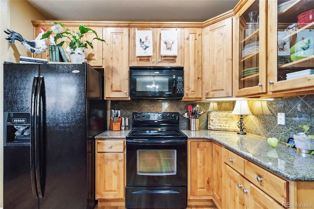 15501 E 112th Ave Unit 20C, Commerce City, CO 80022 - kitchen featuring black appliances, light stone counters, tasteful backsplash, and glass insert cabinets