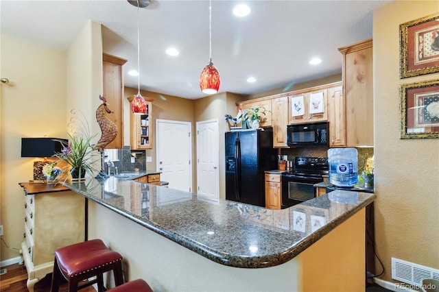 15501 E 112th Ave Unit 20C, Commerce City, CO 80022 - kitchen featuring black appliances, tasteful backsplash, recessed lighting, a peninsula, and pendant lighting