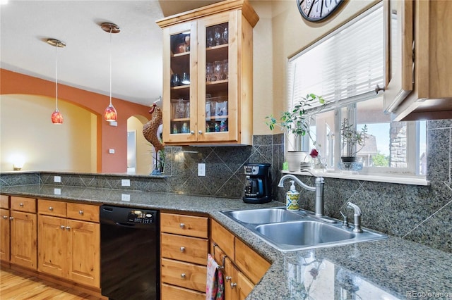 15501 E 112th Ave Unit 20C, Commerce City, CO 80022 - kitchen featuring dishwasher, a sink, arched walkways, hanging light fixtures, and decorative backsplash