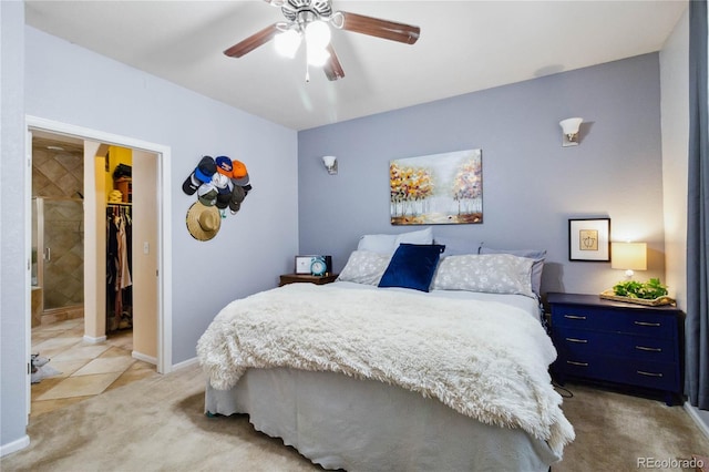 15501 E 112th Ave Unit 20C, Commerce City, CO 80022 - bedroom featuring light carpet, a walk in closet, a ceiling fan, a closet, and baseboards