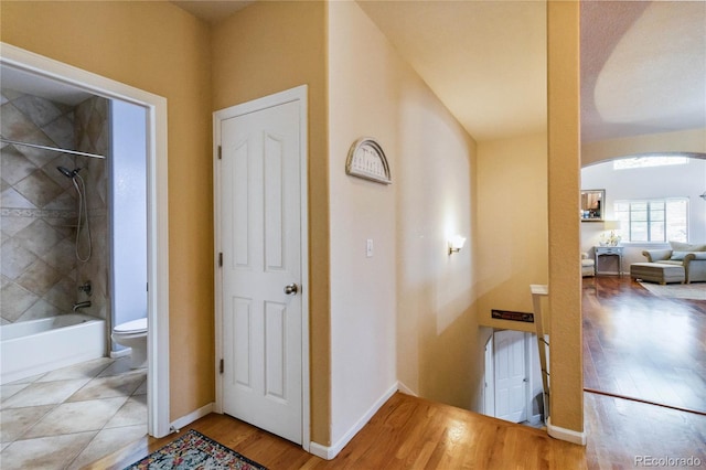 15501 E 112th Ave Unit 20C, Commerce City, CO 80022 - corridor featuring arched walkways, wood finished floors, and baseboards