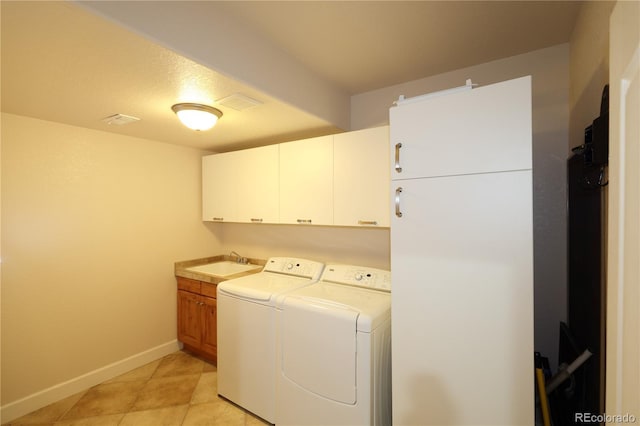 15501 E 112th Ave Unit 20C, Commerce City, CO 80022 - washroom with cabinet space, washer and dryer, baseboards, and light tile patterned floors