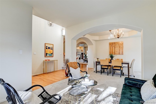 carpeted living room with an inviting chandelier