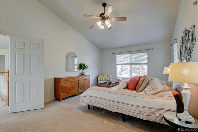 carpeted bedroom with ceiling fan and high vaulted ceiling