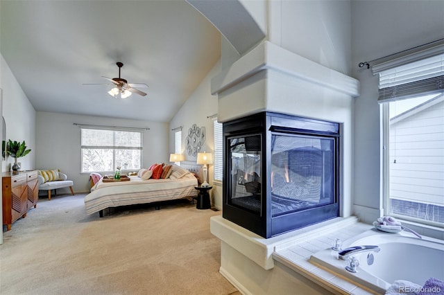 bedroom featuring ceiling fan, light carpet, and vaulted ceiling