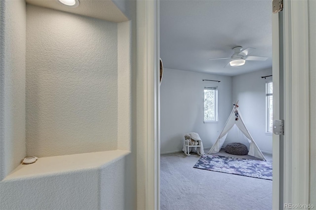 bedroom featuring ceiling fan and light carpet