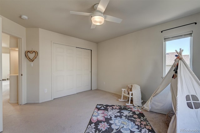 rec room with ceiling fan and light colored carpet