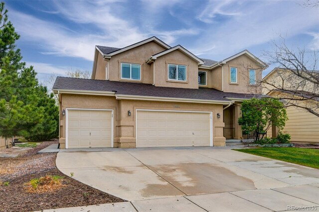 1460 Lily Lake Dr, Colorado Springs, CO 80921 - view of front of home with a garage, driveway, and stucco siding