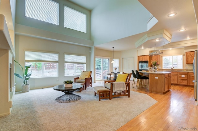 1460 Lily Lake Dr, Colorado Springs, CO 80921 - living room with light wood-type flooring, recessed lighting, and an inviting chandelier