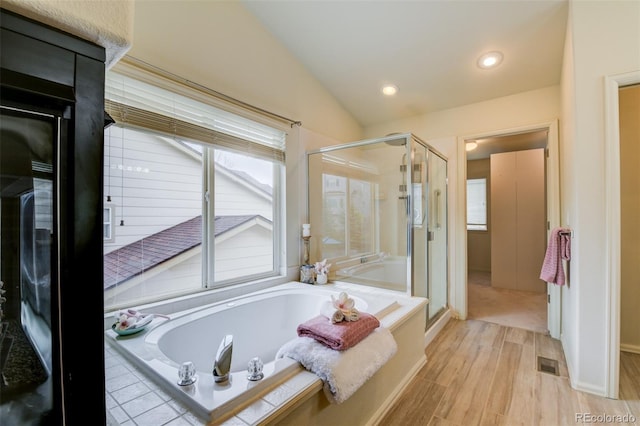 1460 Lily Lake Dr, Colorado Springs, CO 80921 - full bath featuring visible vents, plenty of natural light, wood finished floors, and a stall shower