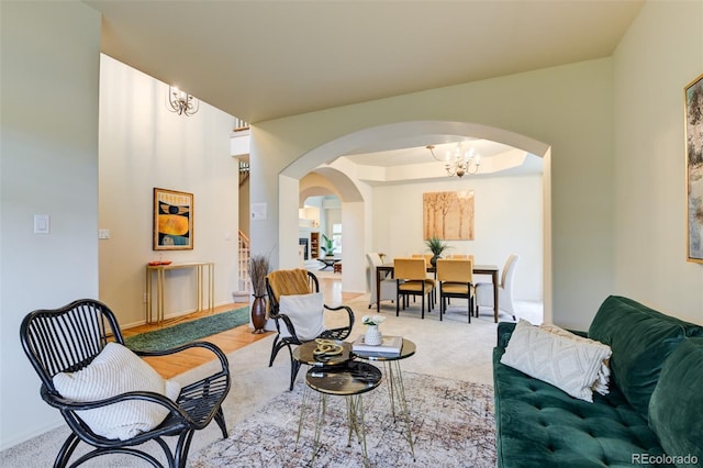 1460 Lily Lake Dr, Colorado Springs, CO 80921 - carpeted living area featuring an inviting chandelier and arched walkways