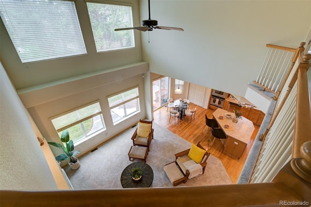 1460 Lily Lake Dr, Colorado Springs, CO 80921 - living area with a ceiling fan, a high ceiling, visible vents, and wood finished floors