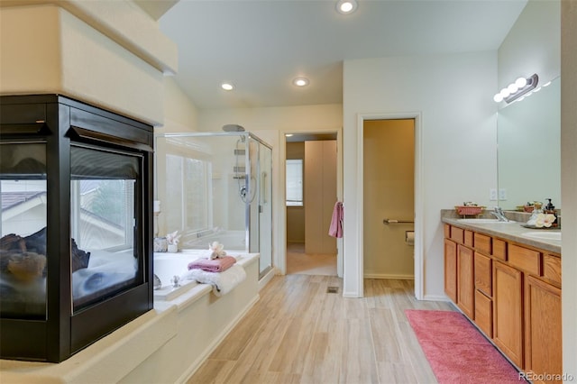 1460 Lily Lake Dr, Colorado Springs, CO 80921 - full bath with double vanity, a bath, a stall shower, a sink, and recessed lighting
