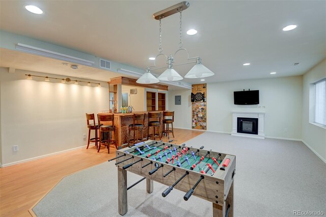 1460 Lily Lake Dr, Colorado Springs, CO 80921 - game room with recessed lighting, visible vents, bar area, and a glass covered fireplace