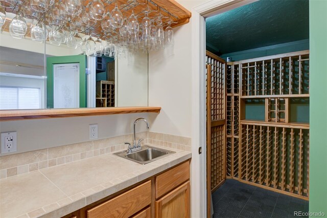 1460 Lily Lake Dr, Colorado Springs, CO 80921 - wine cellar with a sink, tile patterned floors, and indoor wet bar