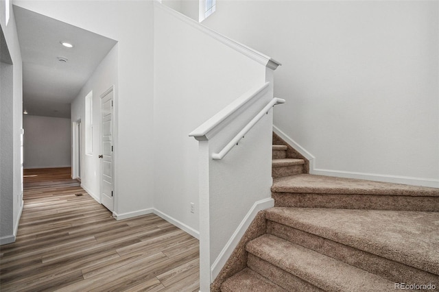 stairway with hardwood / wood-style floors