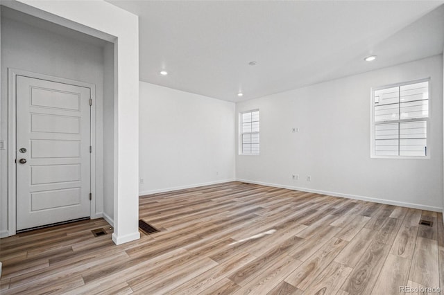 spare room featuring light wood-type flooring