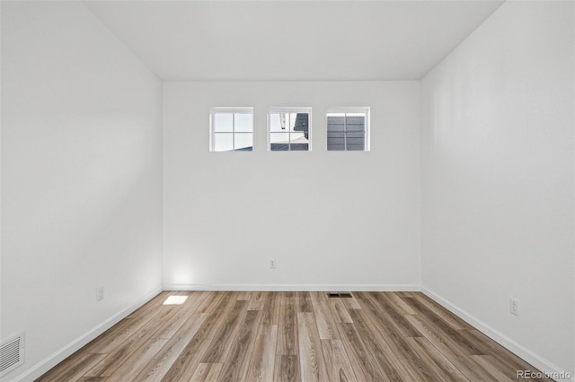 spare room featuring hardwood / wood-style flooring