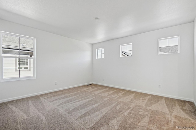 unfurnished room with carpet flooring