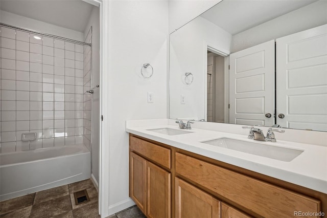 bathroom featuring tiled shower / bath and vanity