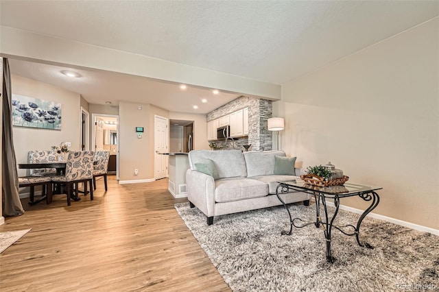 13704 E Lehigh Ave Unit D, Aurora, CO 80014 - living area featuring light wood finished floors, baseboards, and recessed lighting