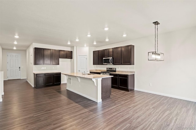 kitchen with stainless steel appliances, baseboards, and dark wood-style floors