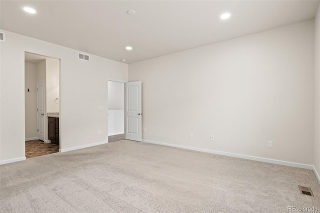 unfurnished bedroom with carpet floors, recessed lighting, visible vents, and baseboards