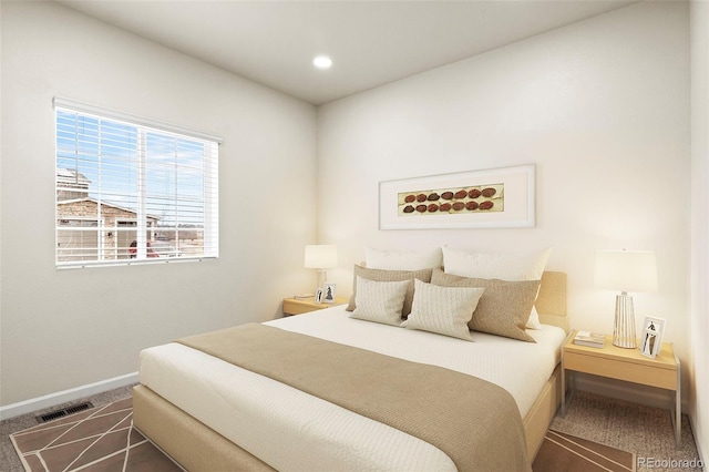 bedroom featuring carpet floors, recessed lighting, visible vents, and baseboards