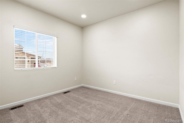 carpeted spare room featuring recessed lighting, visible vents, and baseboards