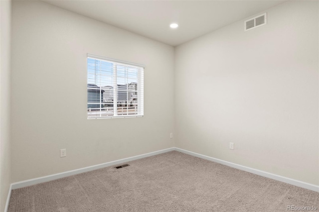 carpeted spare room with recessed lighting, visible vents, and baseboards