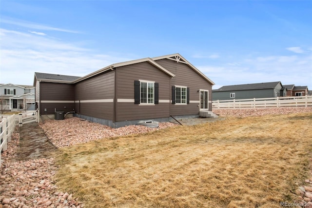 view of property exterior featuring central AC and fence