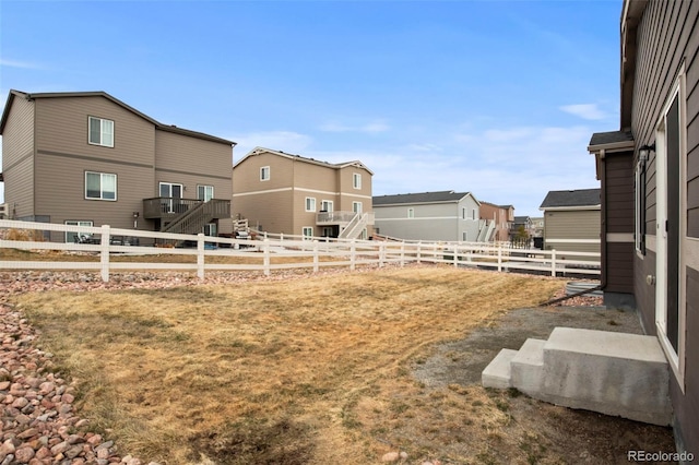 view of yard with a fenced backyard and a residential view