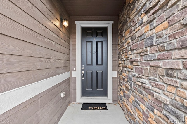 view of exterior entry featuring stone siding