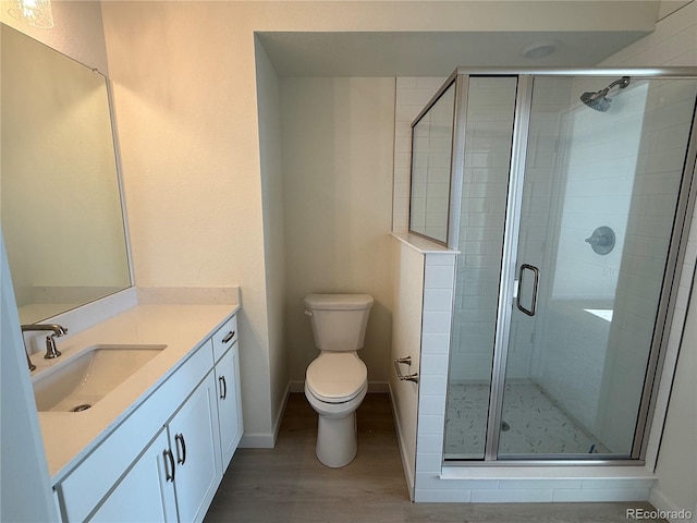 bathroom with vanity, hardwood / wood-style floors, toilet, and walk in shower