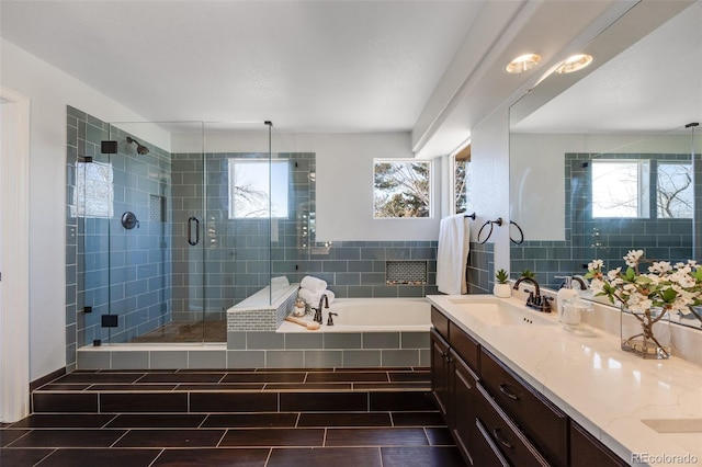 full bath featuring a garden tub, a shower stall, wood finish floors, and vanity