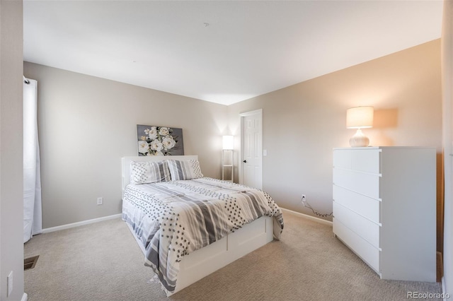 bedroom with light carpet, visible vents, and baseboards