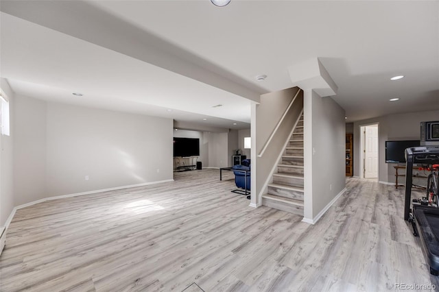 below grade area featuring baseboards, stairway, wood finished floors, and recessed lighting