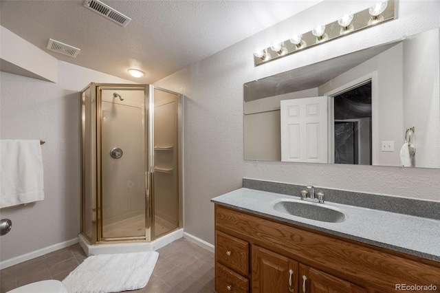 full bath featuring a shower stall, visible vents, and a textured ceiling