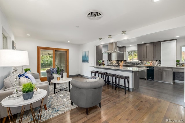 living room with dark wood-type flooring, recessed lighting, baseboards, and visible vents