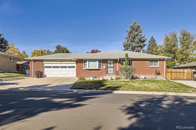 ranch-style home featuring a garage and a front yard