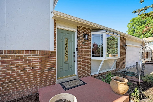 6248 W 75th, Arvada, CO 80003 - entrance to property with a garage, brick siding, and stucco siding