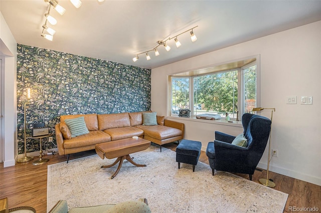 6248 W 75th, Arvada, CO 80003 - living area with wallpapered walls, rail lighting, an accent wall, and wood finished floors