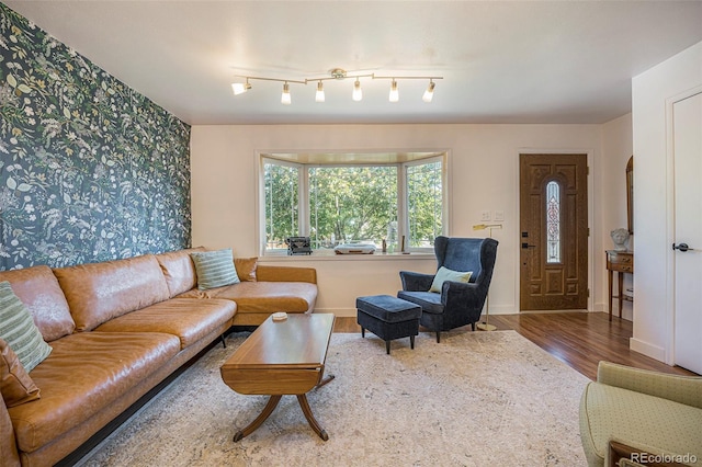 6248 W 75th, Arvada, CO 80003 - living room with wood finished floors, wallpapered walls, and an accent wall