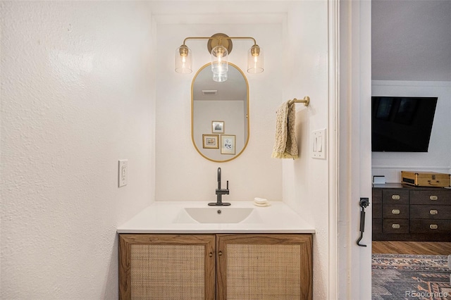 6248 W 75th, Arvada, CO 80003 - bathroom featuring vanity and wood finished floors