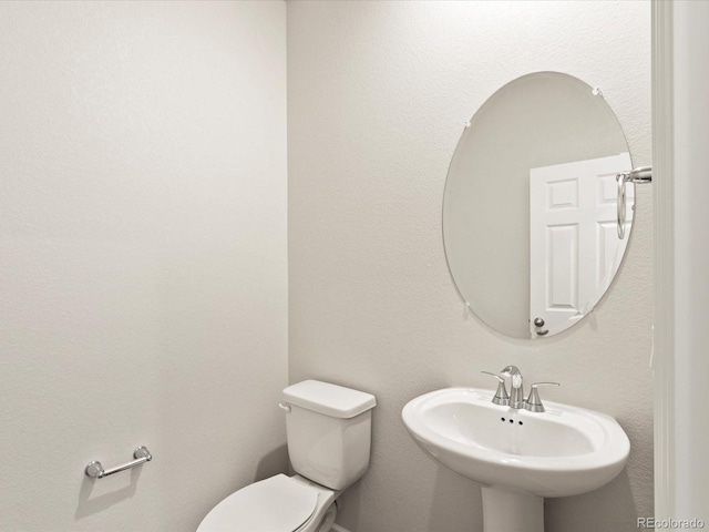 bathroom featuring a sink and toilet